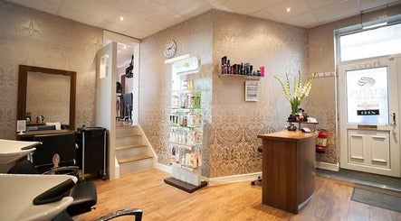 Reception area of Status Hair Design, York, England, GB, featuring sophisticated decor and beauty products.