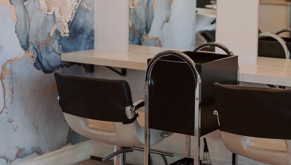 Stylish salon seating with artistic wall design at Smudge, Stellenbosch, Western Cape, ZA.