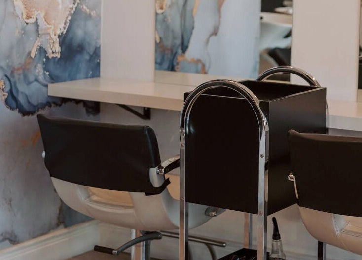 Stylish salon seating with artistic wall design at Smudge, Stellenbosch, Western Cape, ZA.