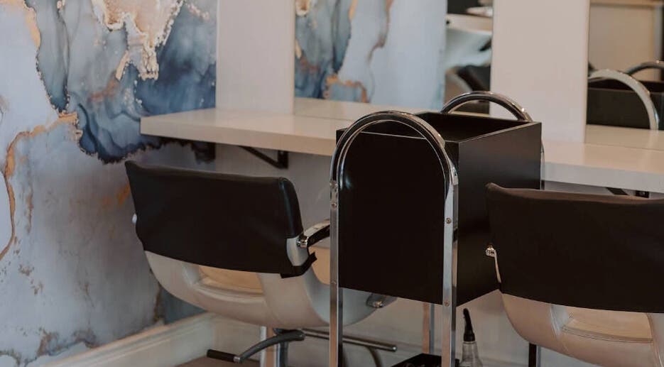 Stylish salon seating with artistic wall design at Smudge, Stellenbosch, Western Cape, ZA.