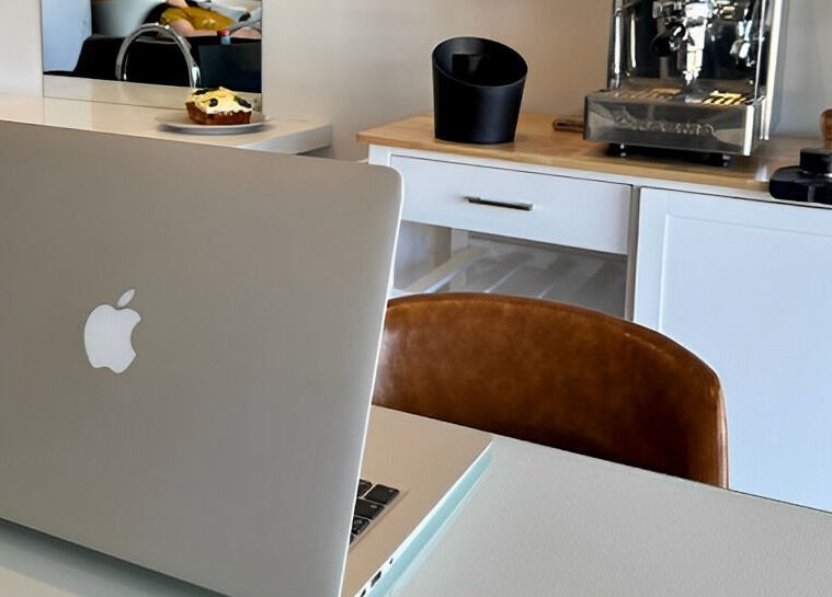 Modern workspace with laptop and coffee setup at Smudge in Stellenbosch, Western Cape, ZA.