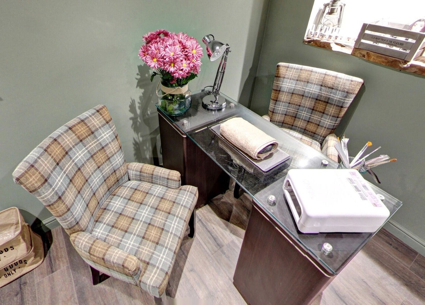 Cozy nail salon setup at Claire @ Vollood, Dunfermline, Scotland, GB with chairs and manicure tools.
