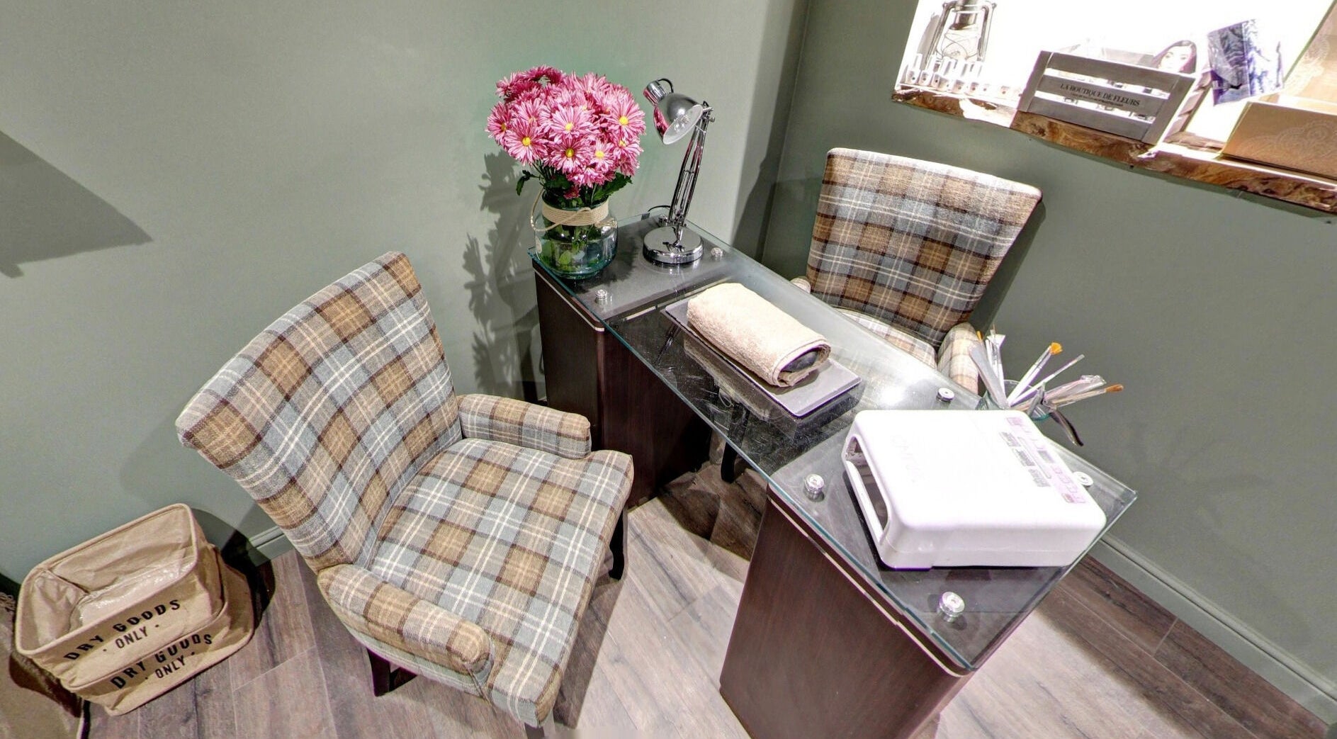 Cozy nail salon setup at Claire @ Vollood, Dunfermline, Scotland, GB with chairs and manicure tools.