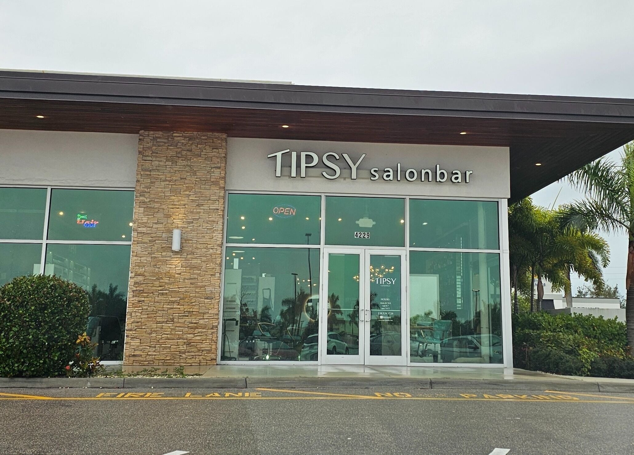 Front view of Tipsy Salonbar Naples, located in Naples, Florida, US, showcasing modern design and inviting entrance.