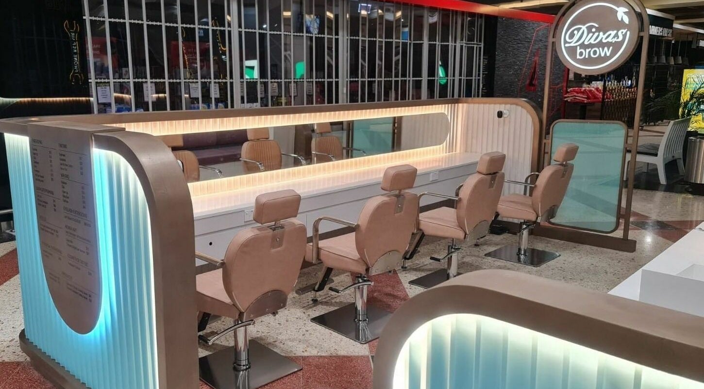 Stylish interior of Divas Brow | Erina Fair, Erina, New South Wales, AU showcasing salon chairs and mirrors.