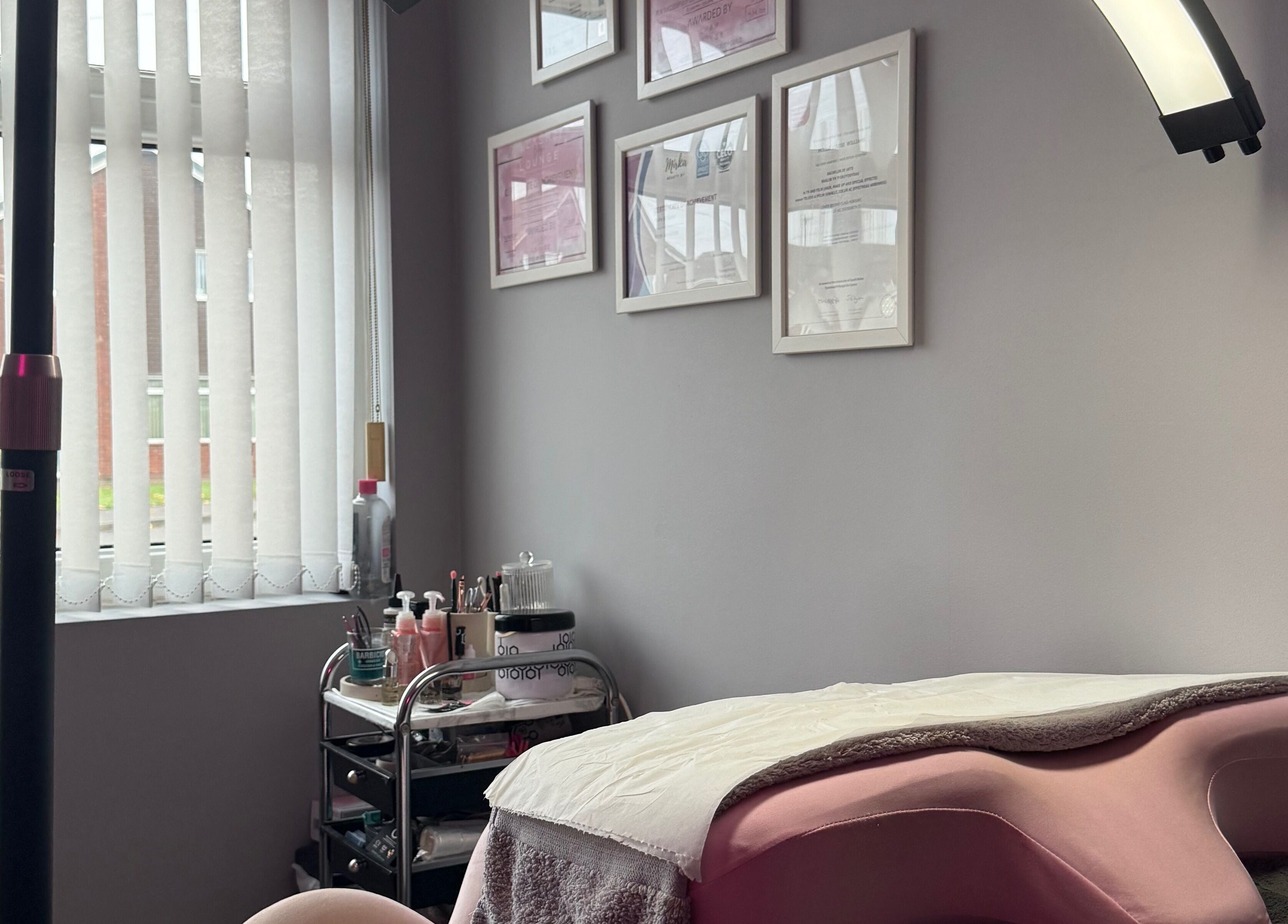 Calm treatment room at Mollie Williams Brows, Barry, Wales, GB, showcasing a cozy aesthetic with decor.