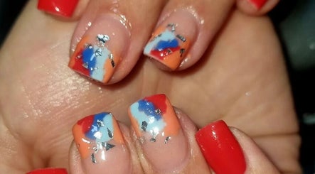 Vibrant nail art at Beautello in Polokwane, Limpopo, ZA, showcasing red, blue, and orange designs.