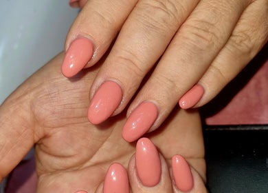 Elegant coral manicure at Beautello, Polokwane, Limpopo, ZA showcasing stylish nail art.