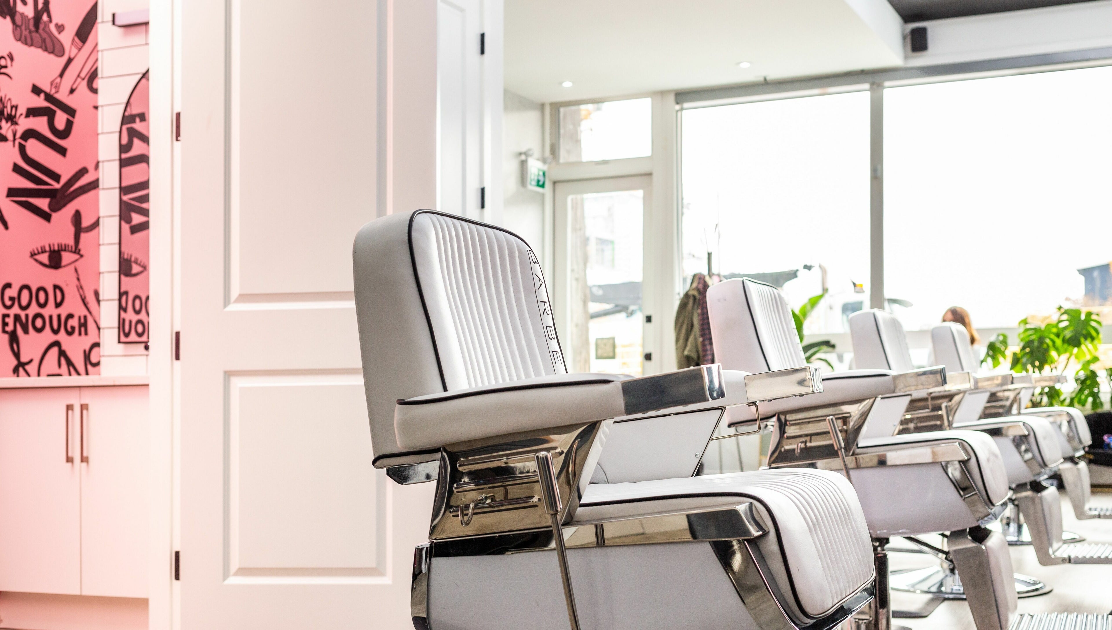 Modern salon chairs at Rebel X, Calgary, Alberta, CA with vibrant decor and bright natural lighting.