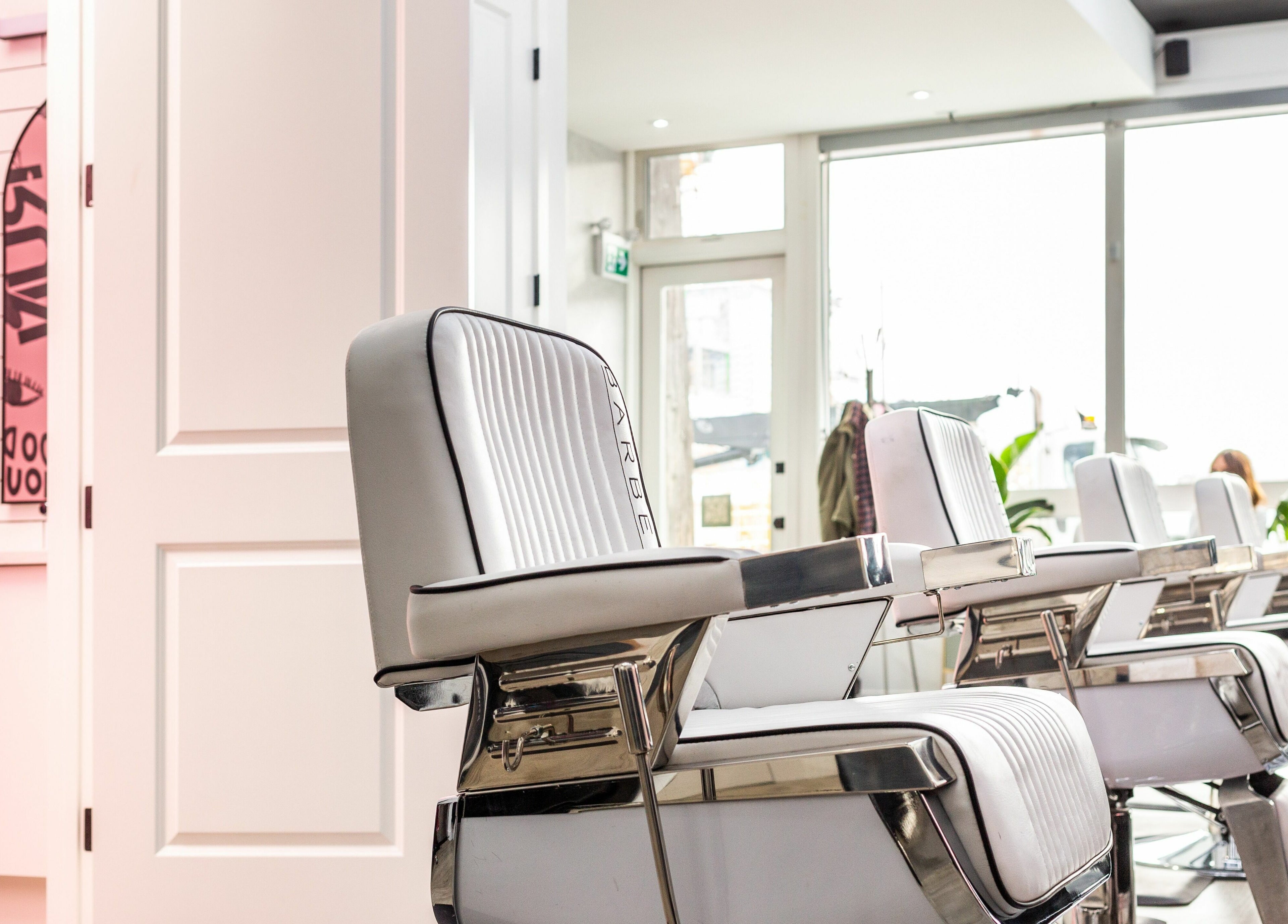 Modern salon chairs at Rebel X, Calgary, Alberta, CA with vibrant decor and bright natural lighting.