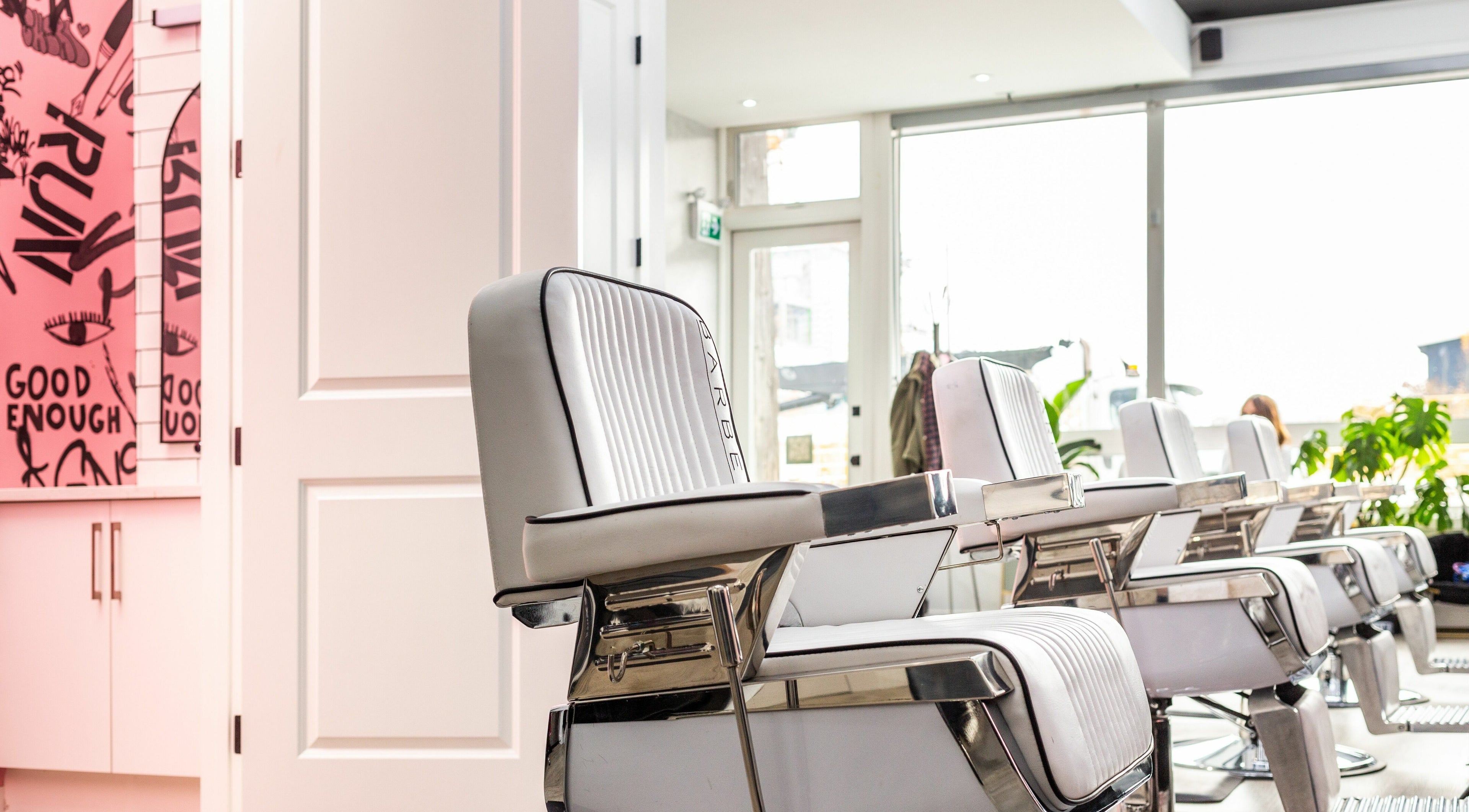 Modern salon chairs at Rebel X, Calgary, Alberta, CA with vibrant decor and bright natural lighting.