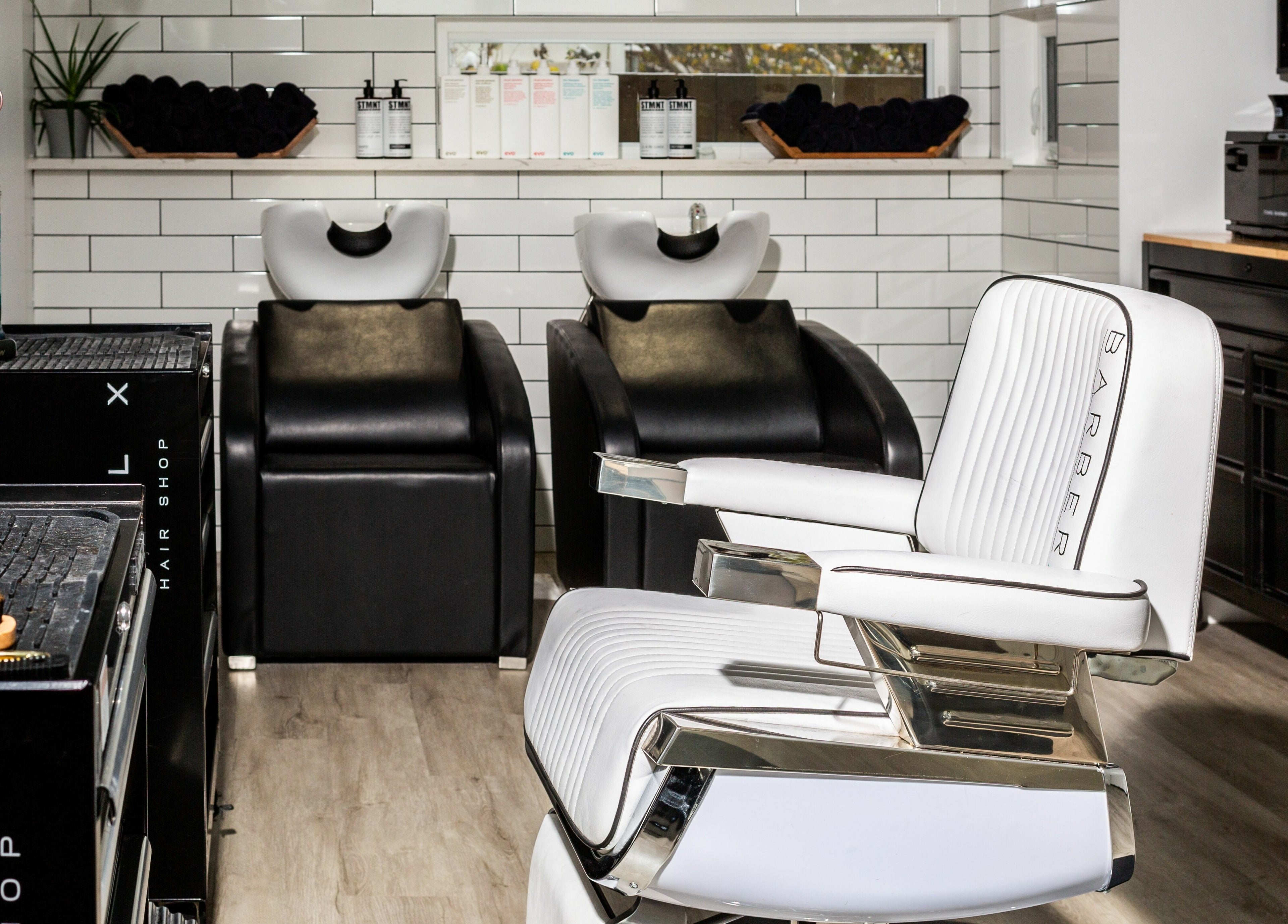 Modern salon interior at Rebel X, Calgary, Alberta, CA, featuring sleek barber chairs and stylish wash stations.