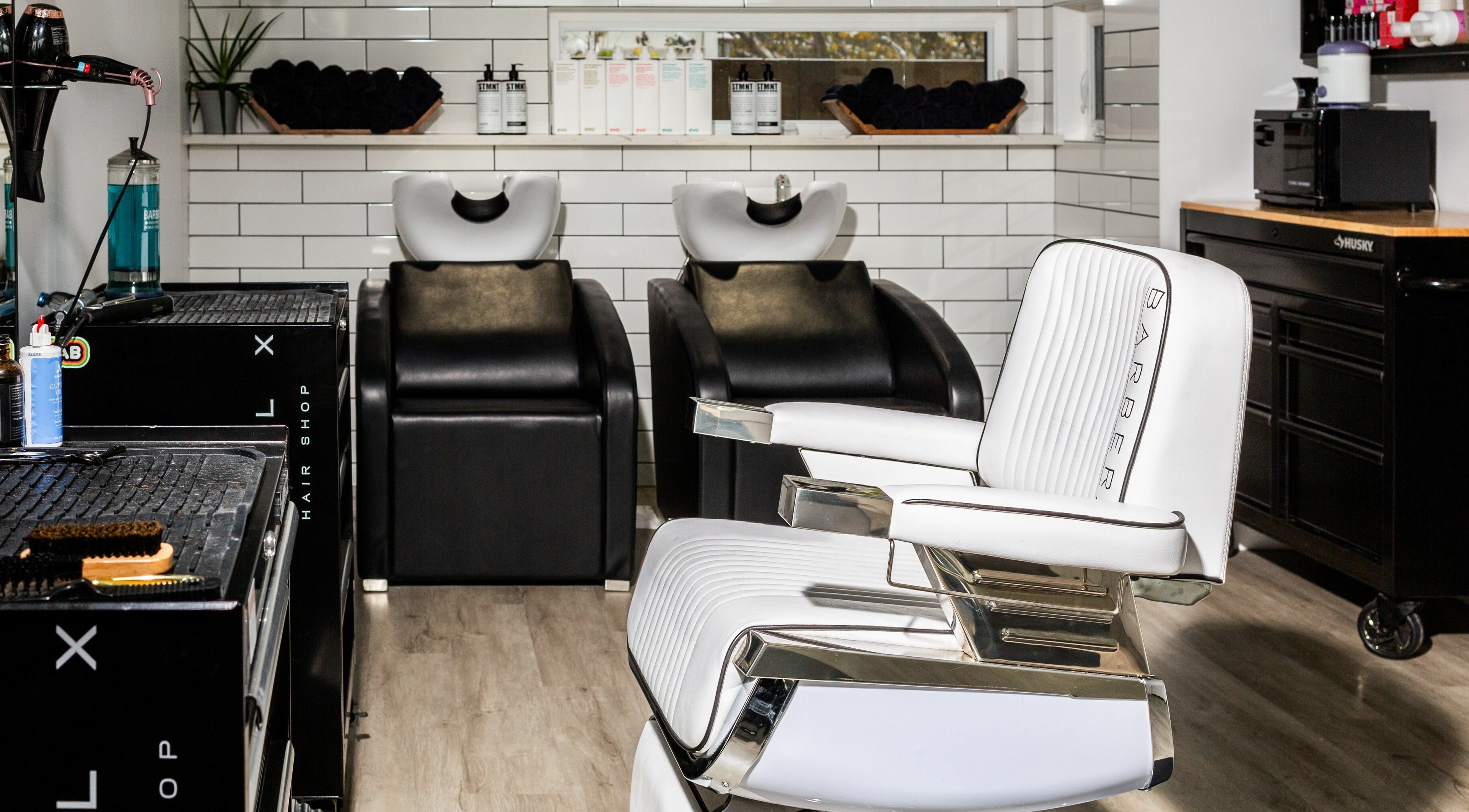 Modern salon interior at Rebel X, Calgary, Alberta, CA, featuring sleek barber chairs and stylish wash stations.
