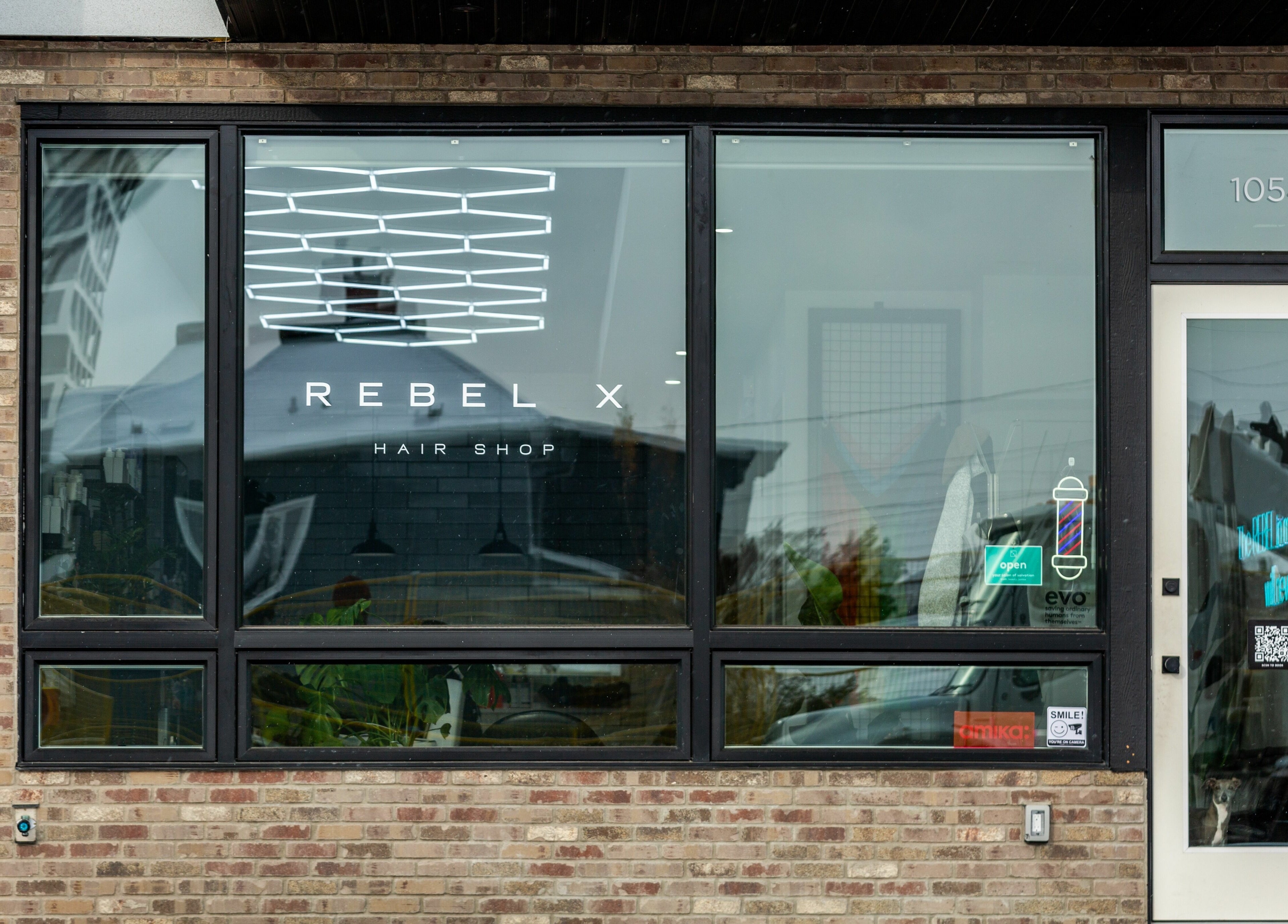 Rebel X storefront featuring sleek design in Calgary, Alberta, CA with clear glass windows and modern signage.