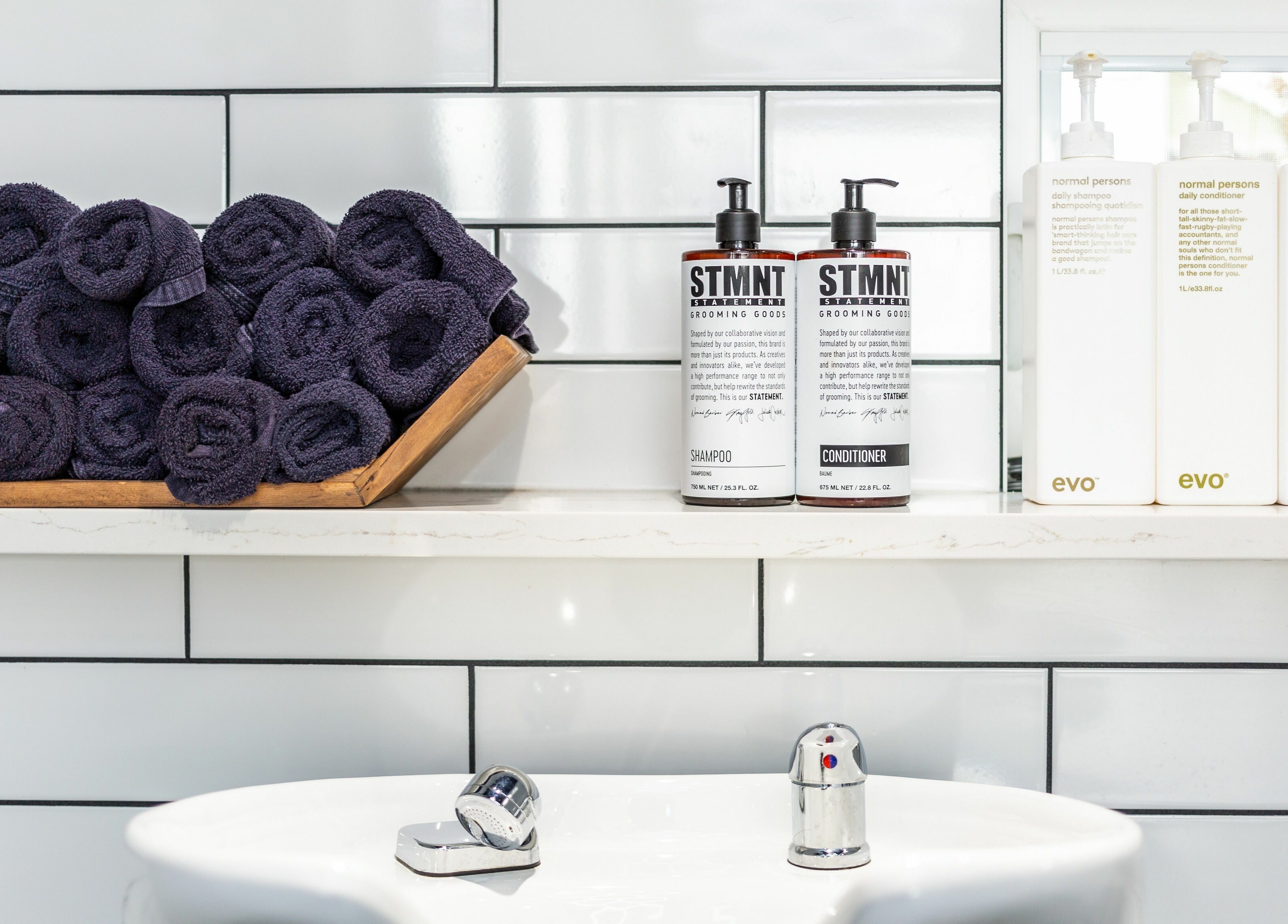 Spa sink area with neatly rolled towels at Rebel X, Calgary, Alberta, CA.