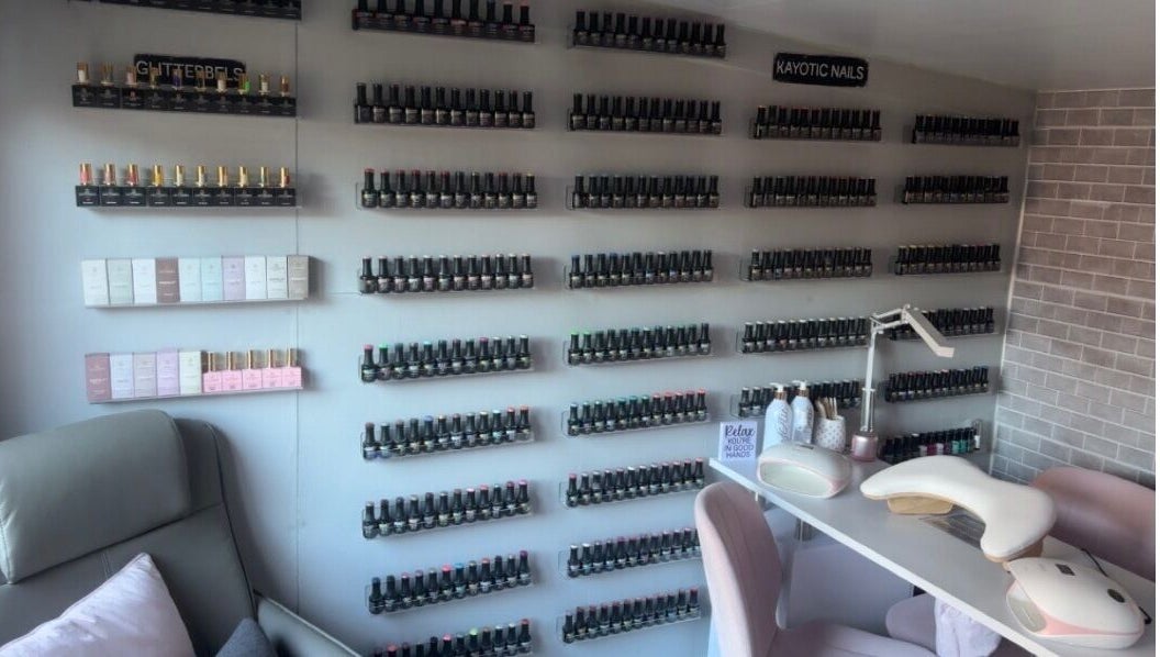 Wall of nail polishes at Kayotic Nails, Andover, England. Bright, organized space for manicures.