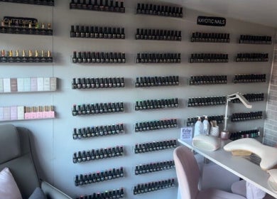 Wall of nail polishes at Kayotic Nails, Andover, England. Bright, organized space for manicures.