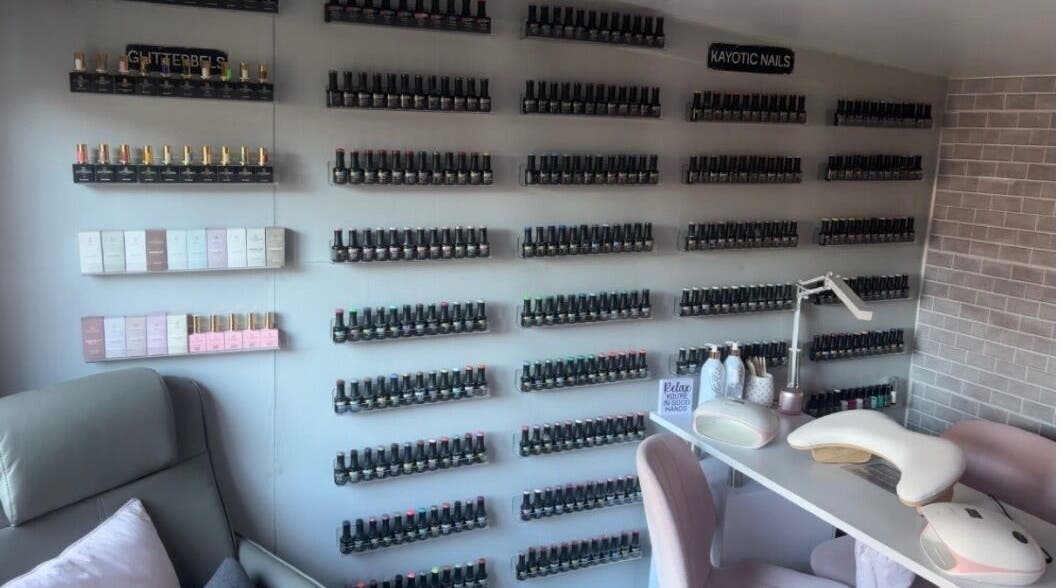 Wall of nail polishes at Kayotic Nails, Andover, England. Bright, organized space for manicures.