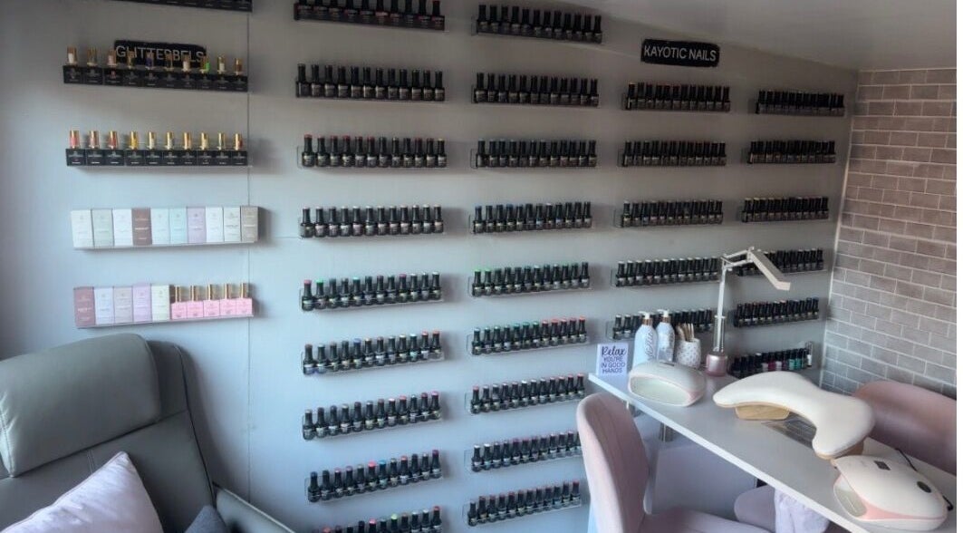 Wall of nail polishes at Kayotic Nails, Andover, England. Bright, organized space for manicures.