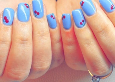 Vibrant blue nails with cherry art from Kayotic Nails, Andover, England, GB.