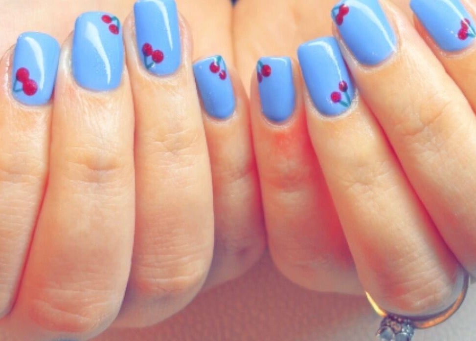Vibrant blue nails with cherry art from Kayotic Nails, Andover, England, GB.