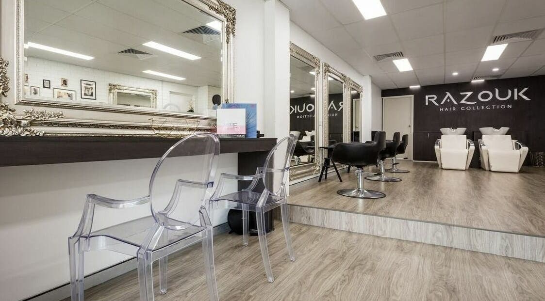 Chic interior of Razouk Hair Collection in Parramatta, New South Wales, AU, featuring stylish salon chairs and mirrors.