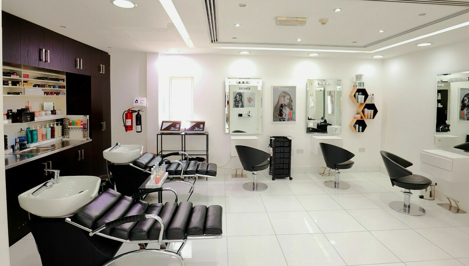 Sleek and modern salon interior at Honeyrose Spa & Salon, Dubai, Dubai, AE, featuring plush black chairs.