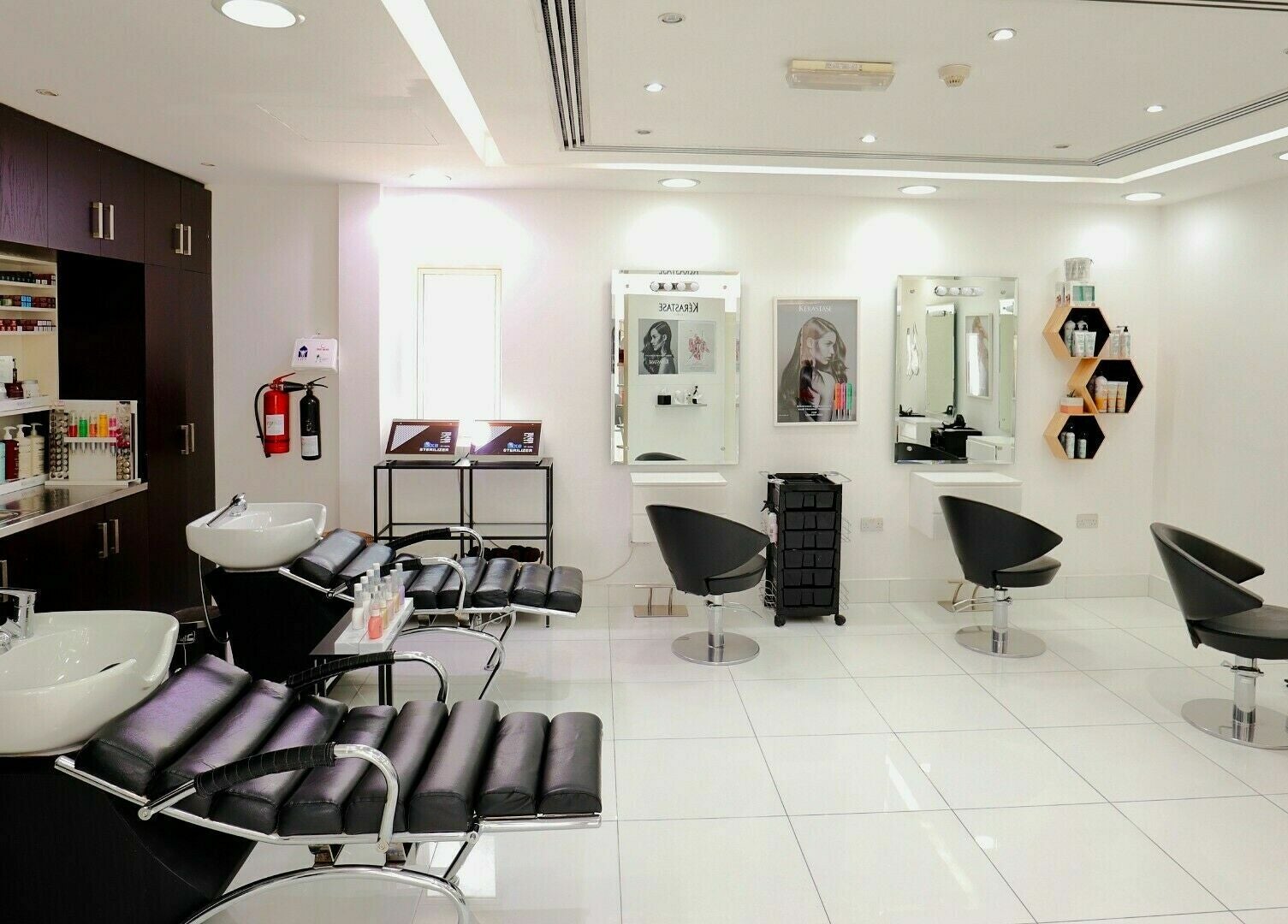 Sleek and modern salon interior at Honeyrose Spa & Salon, Dubai, Dubai, AE, featuring plush black chairs.