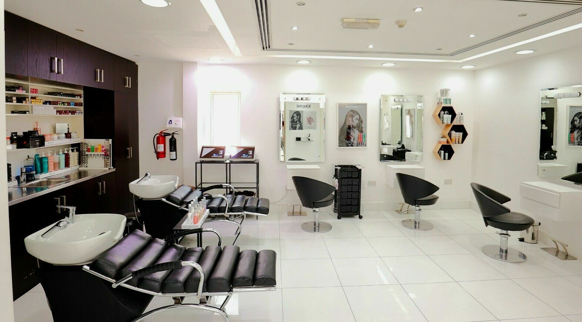 Sleek and modern salon interior at Honeyrose Spa & Salon, Dubai, Dubai, AE, featuring plush black chairs.