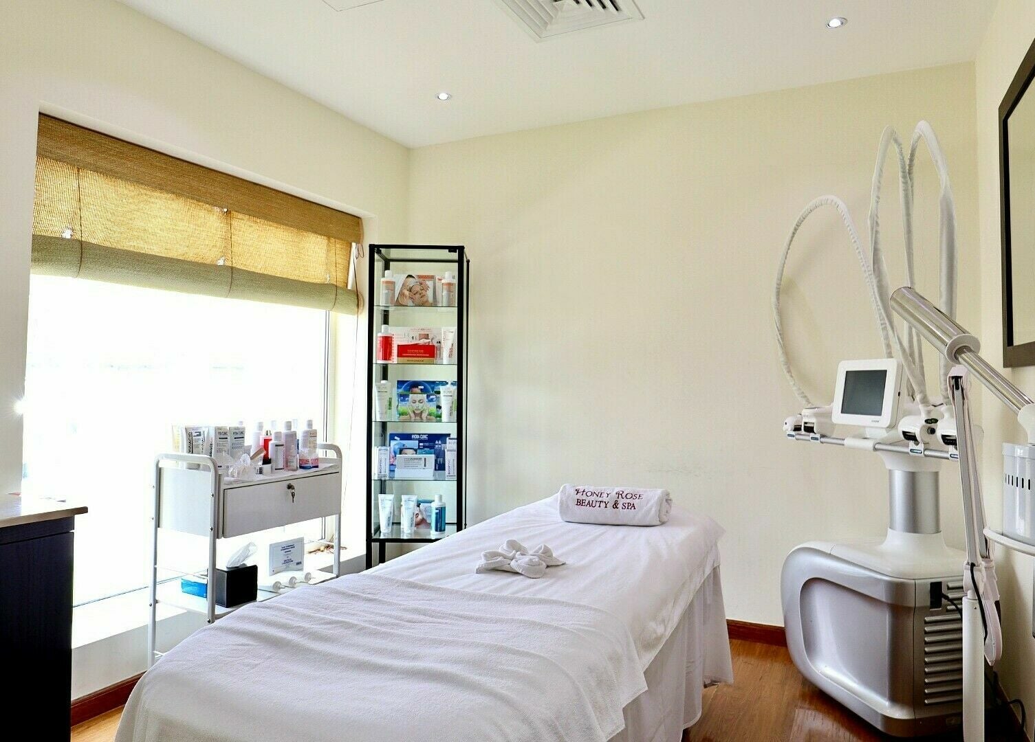 Tranquil treatment room at Honeyrose Spa & Salon, Dubai. Bright light and advanced equipment create a soothing ambiance.