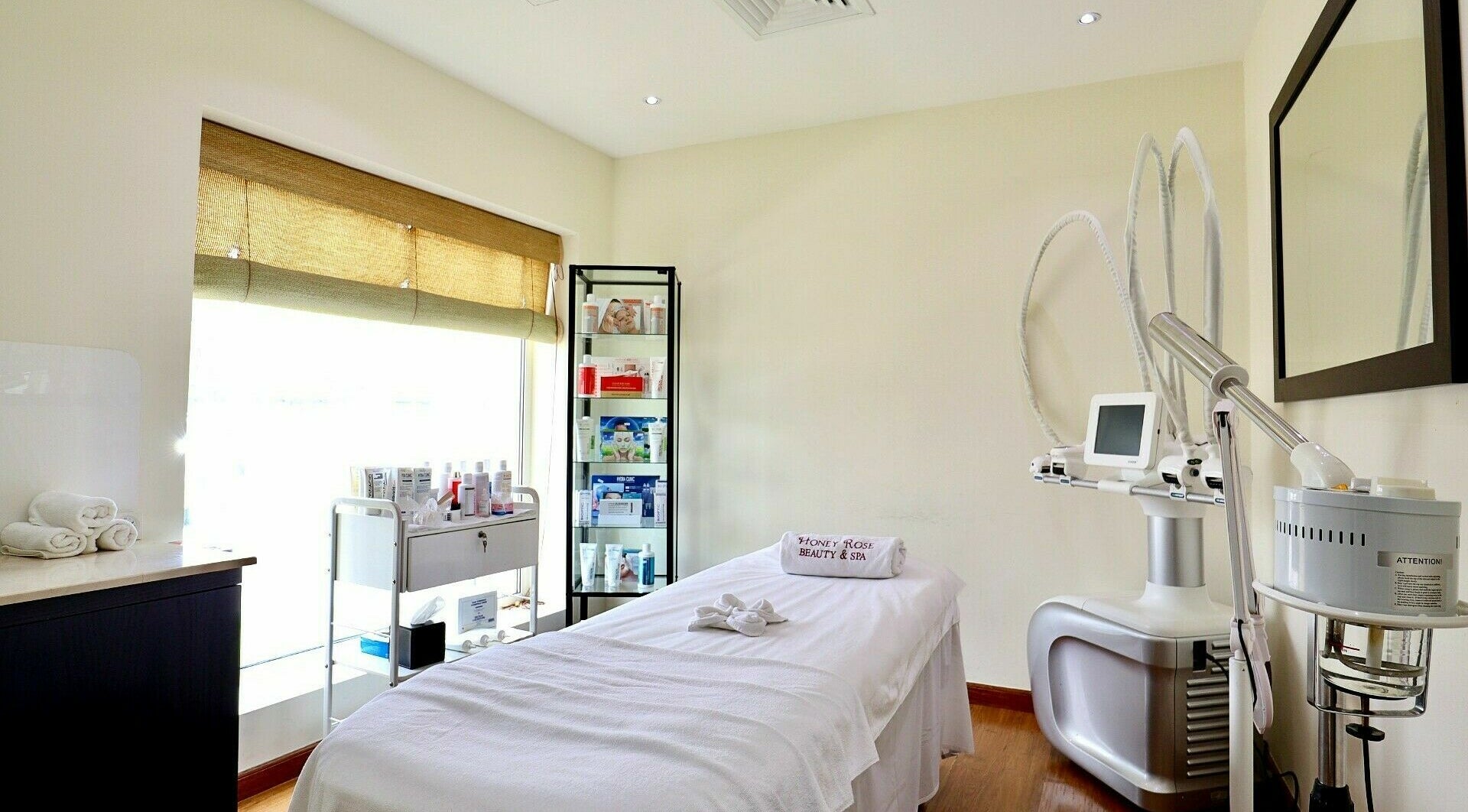 Tranquil treatment room at Honeyrose Spa & Salon, Dubai. Bright light and advanced equipment create a soothing ambiance.