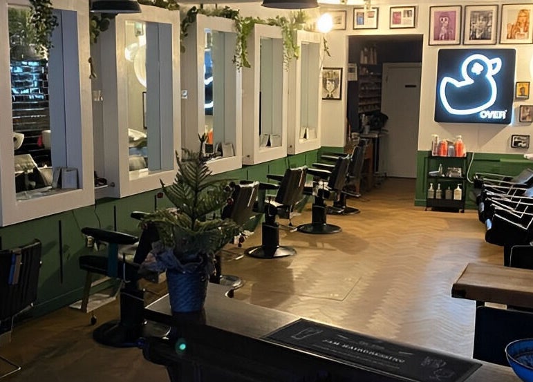 Interior of Jam, a chic beauty salon in Sheffield, England, GB, featuring stylish chairs and elegant decor.