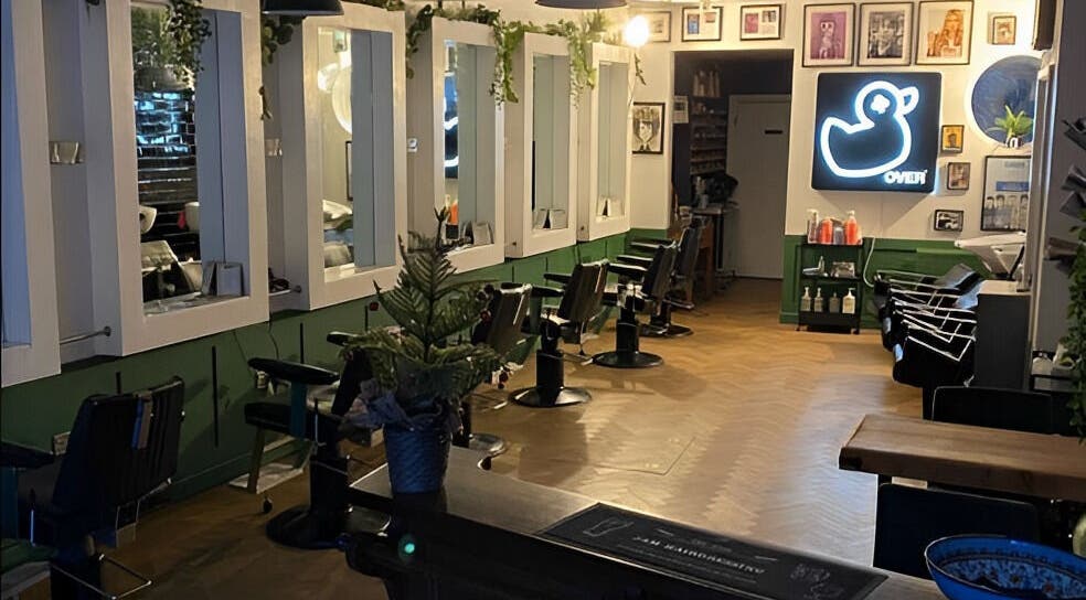 Interior of Jam, a chic beauty salon in Sheffield, England, GB, featuring stylish chairs and elegant decor.