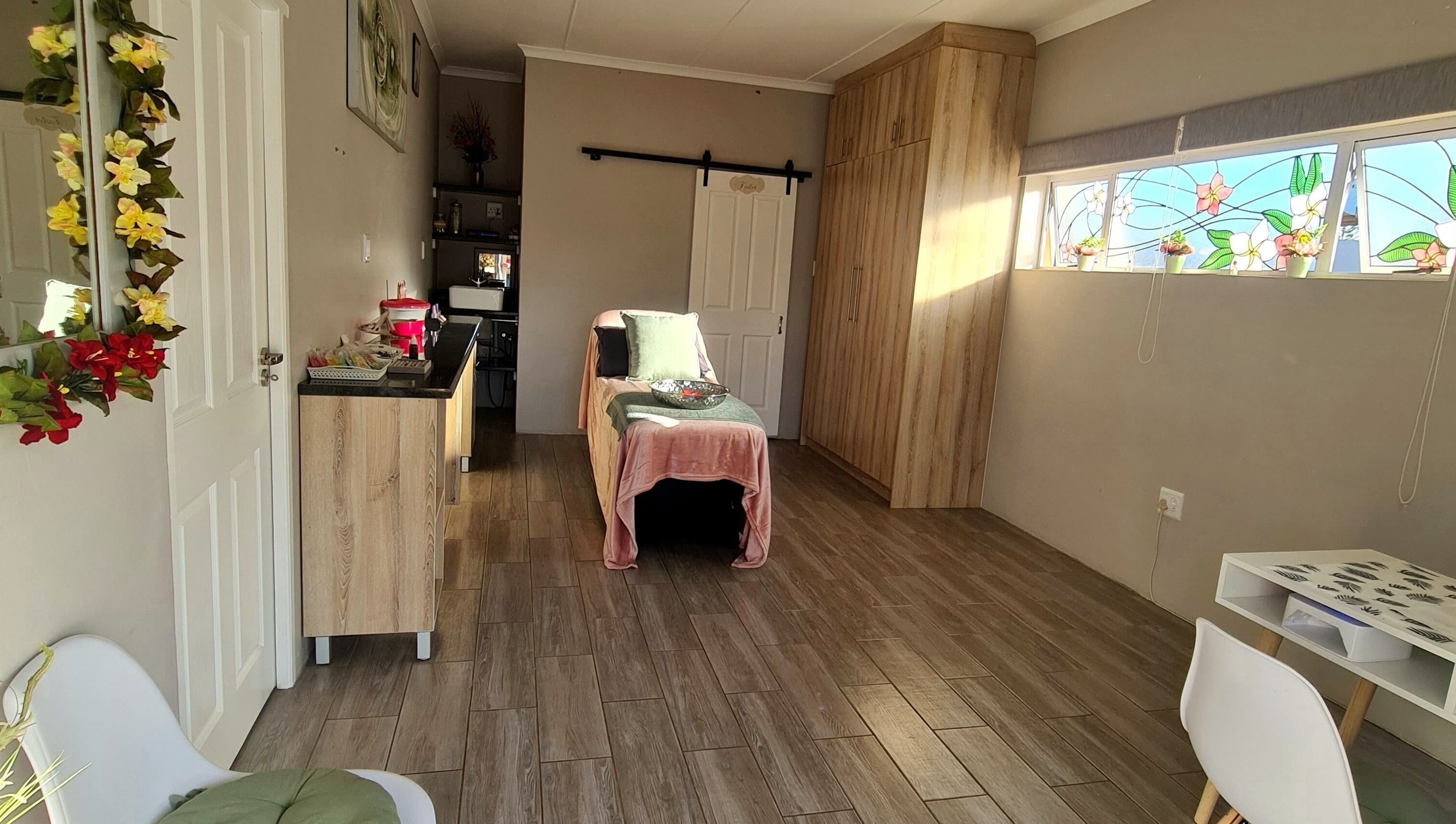 Relaxing spa room at Beauty Secrets in Jeffreys Bay, Eastern Cape, ZA with a massage table and floral decor.