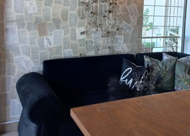 Chic lounge area in Dare to Ink Tattoo Studio, Bloemfontein, Free State, ZA with comfy couch and intricate decor.