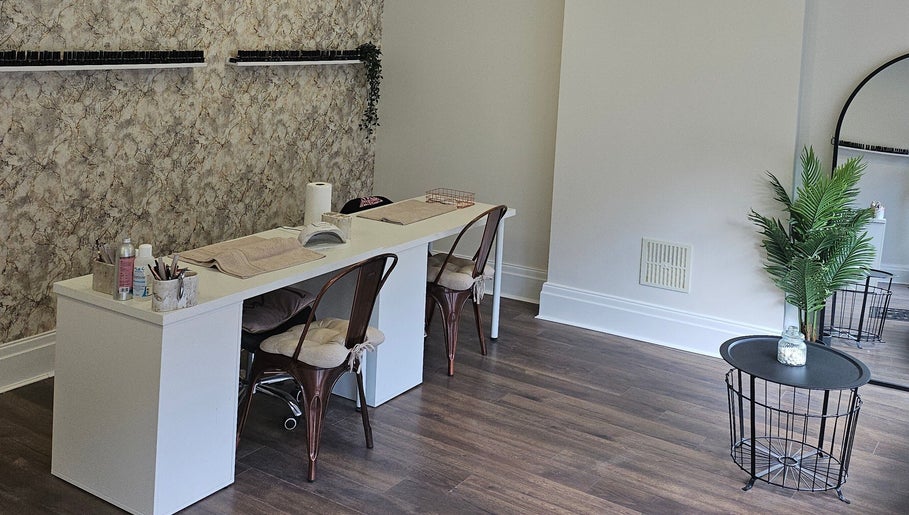 Chic manicure station at Klg Nails & Beauty, Tyldesley, England, GB with stylish chairs and nail polish display.