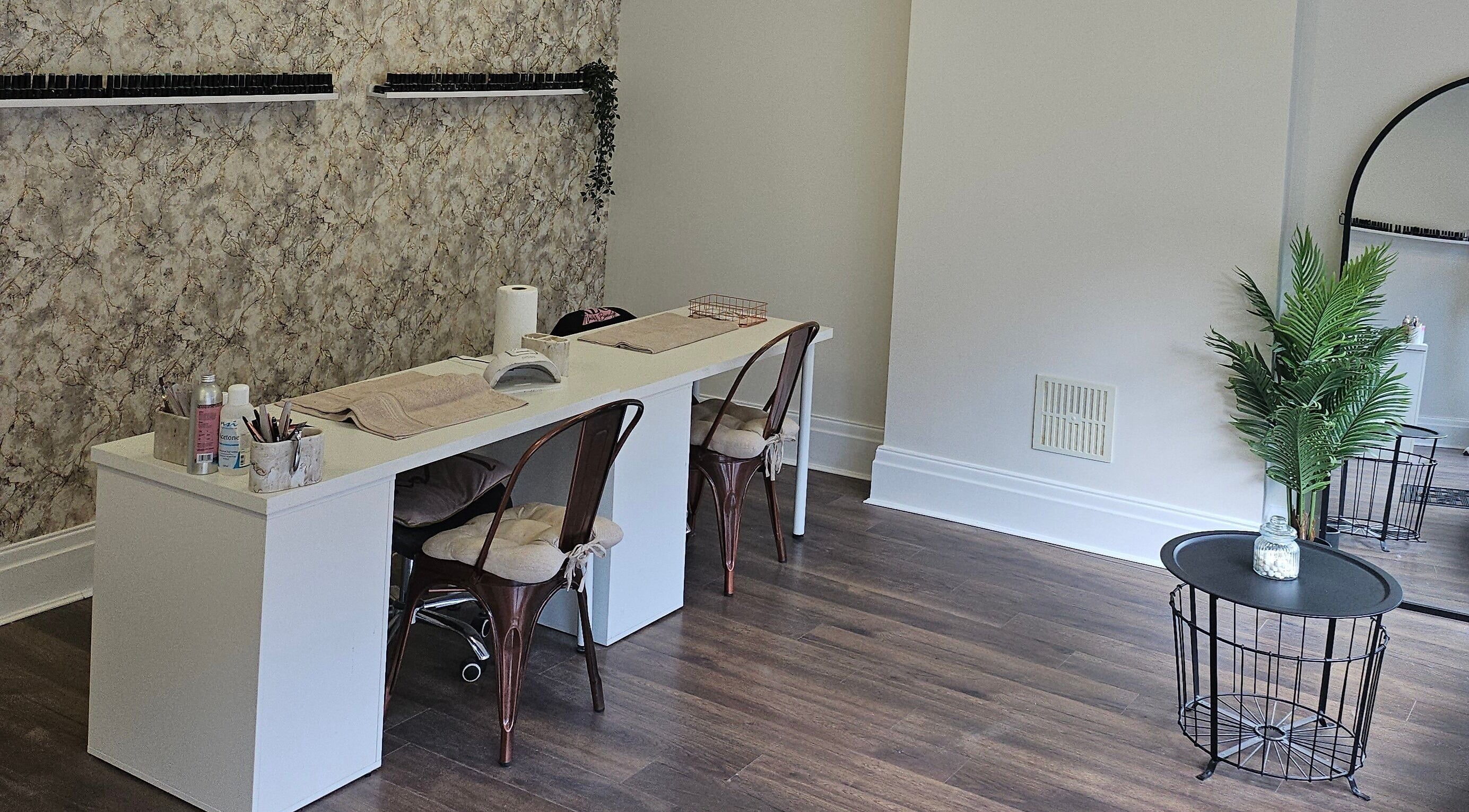 Chic manicure station at Klg Nails & Beauty, Tyldesley, England, GB with stylish chairs and nail polish display.