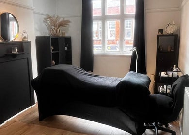 Modern treatment room at Klg Nails & Beauty in Tyldesley, England, GB. Features a stylish black decor and comfortable setup.
