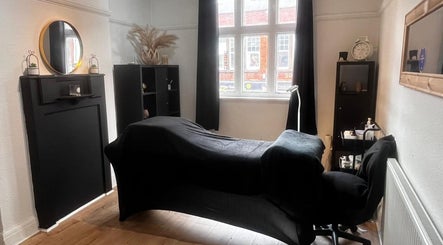 Modern treatment room at Klg Nails & Beauty in Tyldesley, England, GB. Features a stylish black decor and comfortable setup.