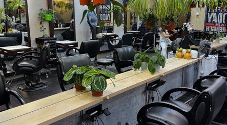 Modern hair salon setup at Expert Hair (Raven Bey), Singapore, SG, featuring stylish chairs and lush greenery.