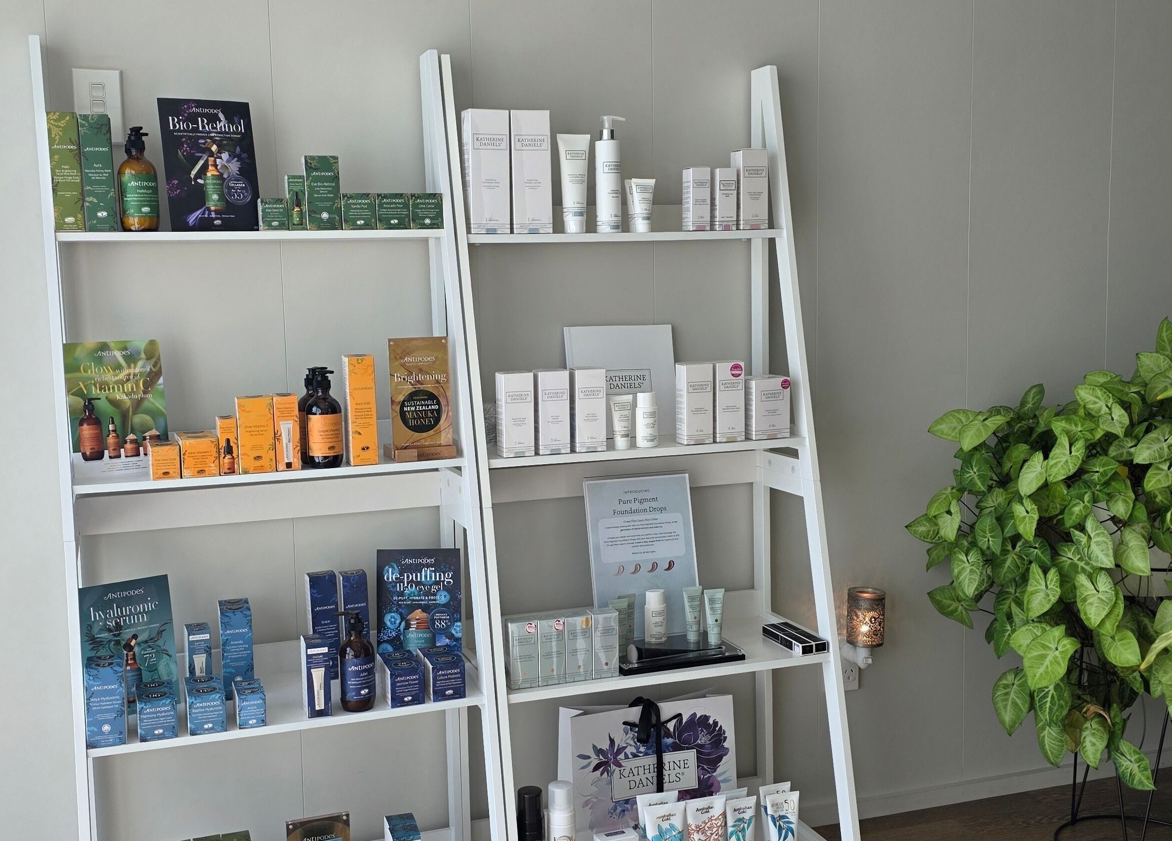 Beauty products display at Beauty by Tania, Auckland, NZ featuring skincare and wellness items on white shelves.