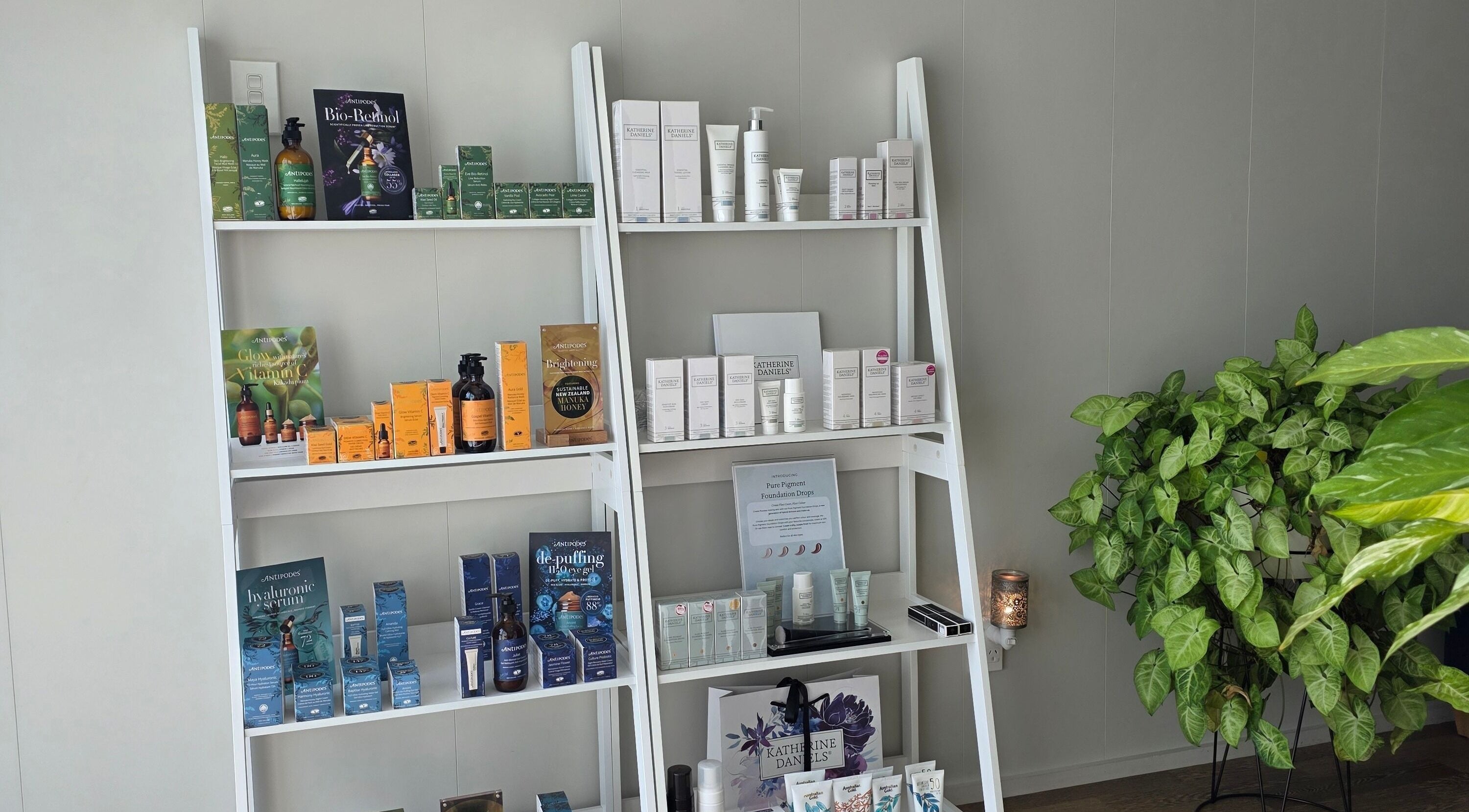 Beauty products display at Beauty by Tania, Auckland, NZ featuring skincare and wellness items on white shelves.
