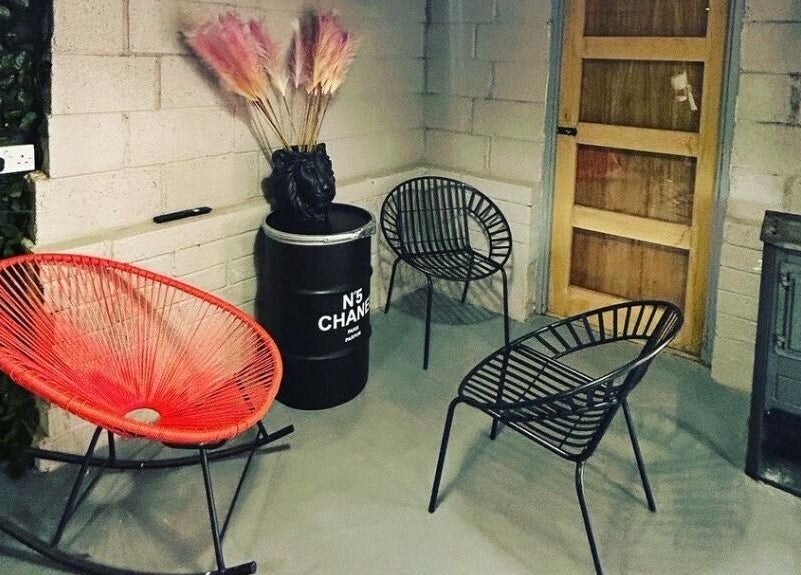 Chic seating at Lady Muck, Bilston, Scotland featuring stylish chairs and rustic decor.