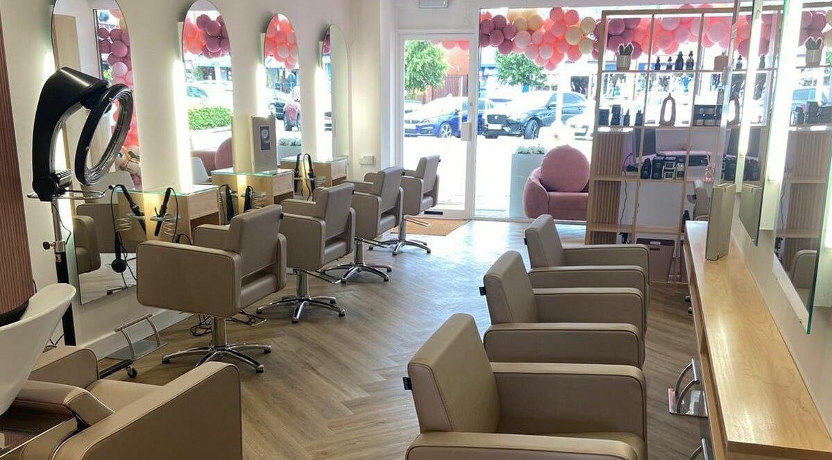 Bright interior of Charlotte Paints Hair Studio in Shirley, England, GB with sleek chairs and modern decor.