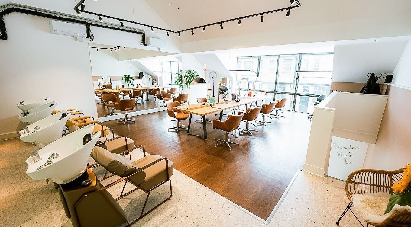 Contemporary salon interior at Somewhere in Queens Park, London, England, GB with chic styling areas.