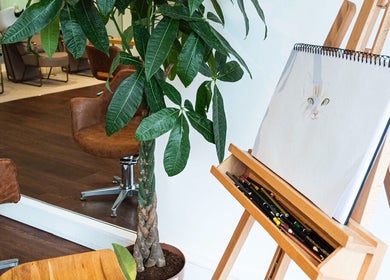 Stylish interior at Somewhere in Queens Park, London, England, GB with art supplies and cozy seating.