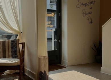 Inviting entrance at Somewhere in Queens Park, London, England, GB, featuring a chair and elegant decor.