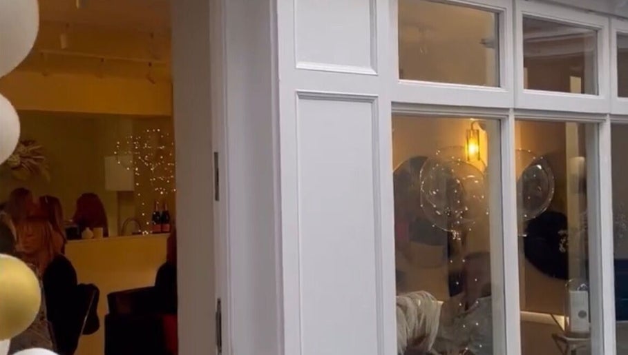 Exterior view of Alex @ Jazmine Love hair salon in Carmarthen, Wales, GB showing stylish interior lighting.