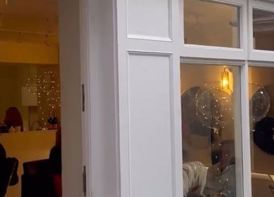 Exterior view of Alex @ Jazmine Love hair salon in Carmarthen, Wales, GB showing stylish interior lighting.