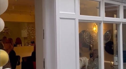 Exterior view of Alex @ Jazmine Love hair salon in Carmarthen, Wales, GB showing stylish interior lighting.